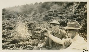 Image of Campbell and Jot. Mother Carey chicken (storm petrel) in hand.